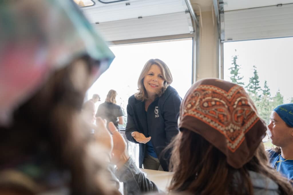 CEO Lidia Soto-Harmon meets with Student Conservation Association members serving in Alaska.