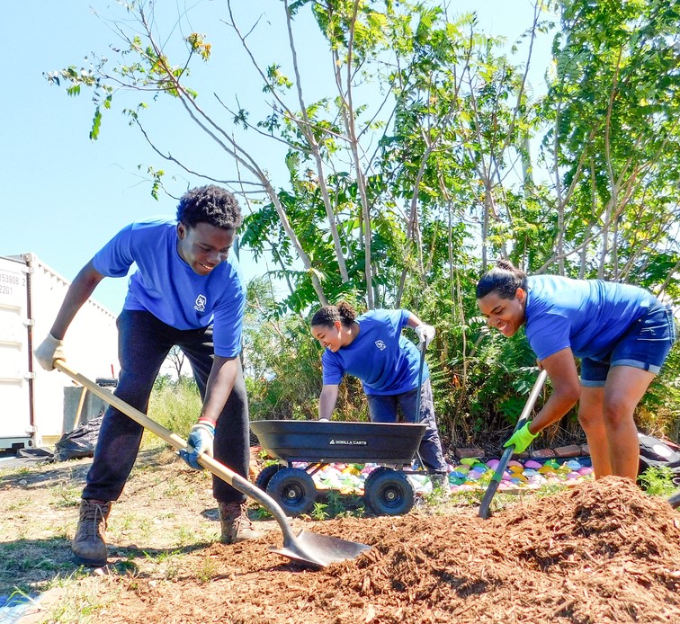 Three crew members planting trees.