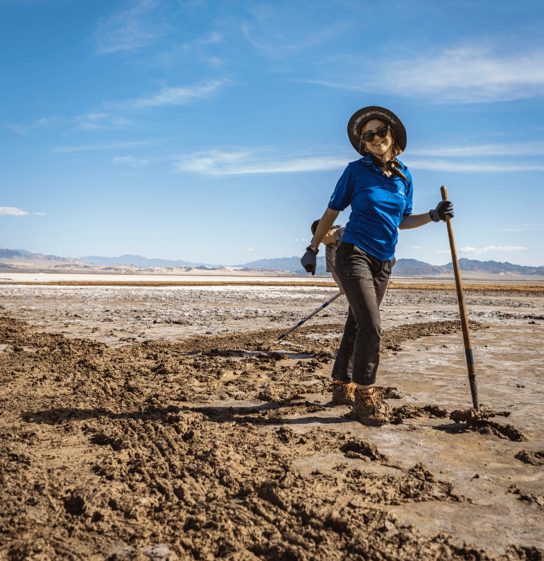 Pearl McCann standing with shovel in the Mojave desert