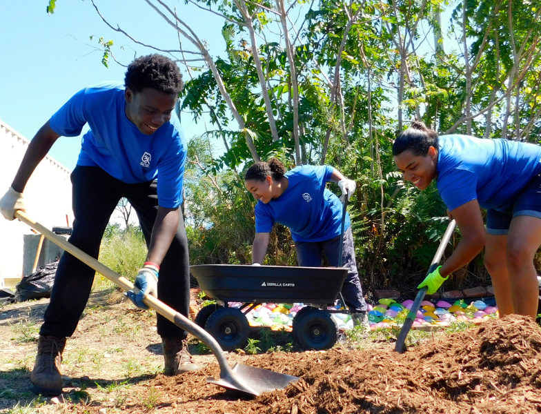 Three SCA crew members planting tree