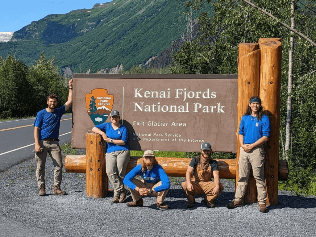 Katmai and Kenai Fjords Trail Crew in front of Kenai Fjords National Park Sign