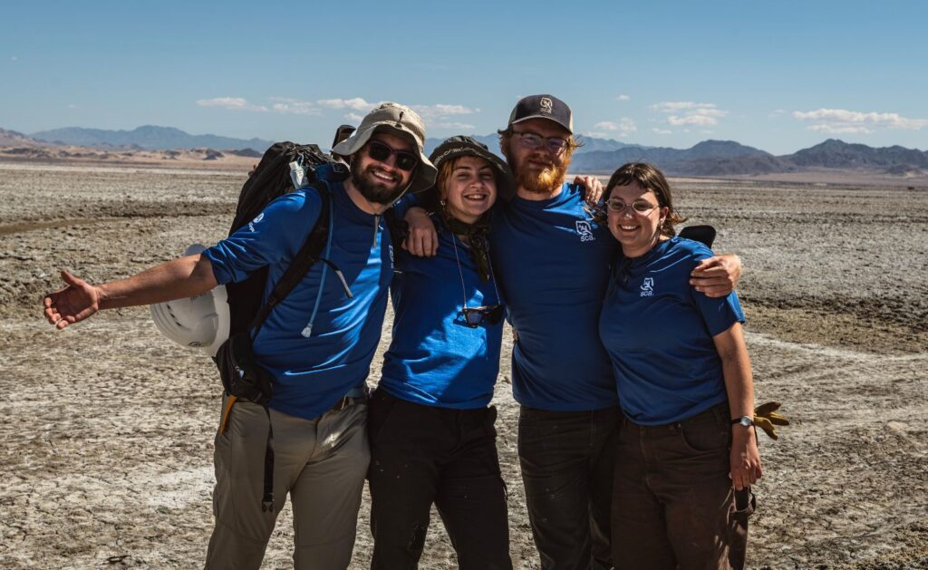 Mojave Desert Restoration Corps crew members posing for a group photo in the desert.