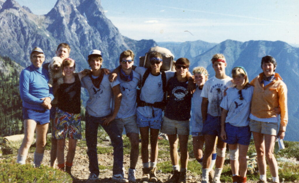 A vintage photo from 1986 shows an SCA crew posing in front of a mountain landscape at North Cascades National Park.