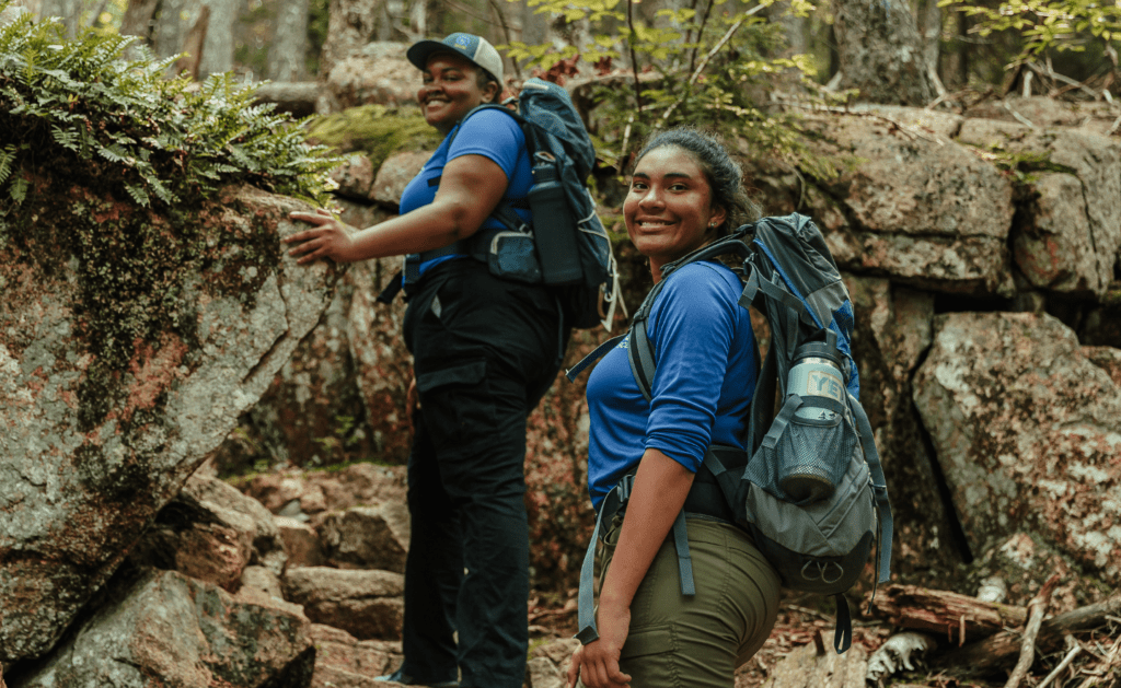 NY Urban Green Acadian Exploration Crew members hiking in woods at Acadia National Park