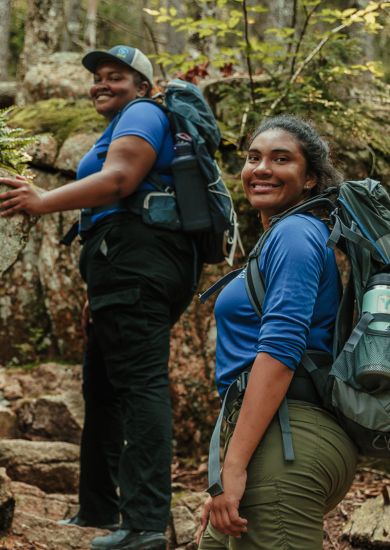 The SCA's Acadian Exploration Crew members hiking in the woods